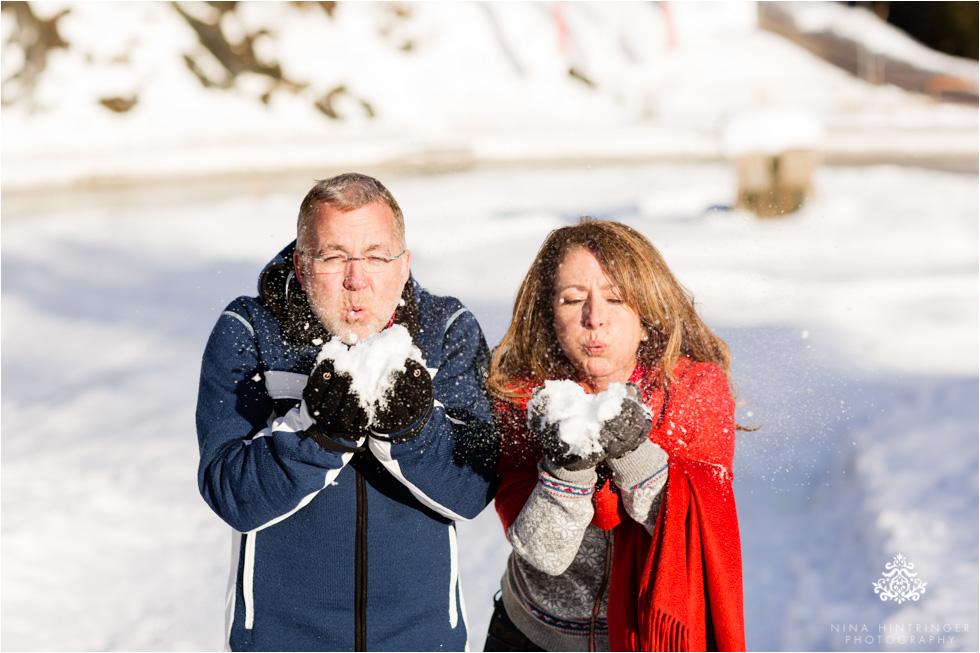 cute couple in the snow blowing snow - Blog of Nina Hintringer Photography - Wedding Photography, Wedding Reportage and Destination Weddings