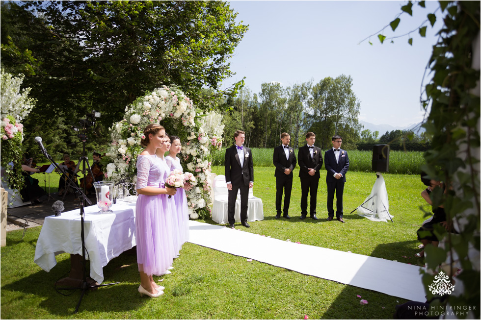 Groom and bridal party waiting for bride to walk down the aisle with her dad at Schloss Prielau, Zell am See, Salzburg, Austria - Blog of Nina Hintringer Photography - Wedding Photography, Wedding Reportage and Destination Weddings
