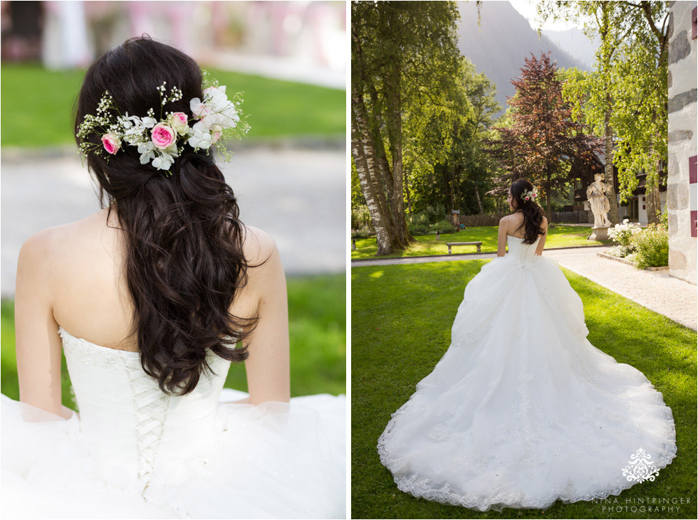 Details of the bride and her beautiful flowers in her hair as well as her amazing wedding gown shot at Schloss Prielau, Zell am See, Salzburg, Austria - Blog of Nina Hintringer Photography - Wedding Photography, Wedding Reportage and Destination Weddings
